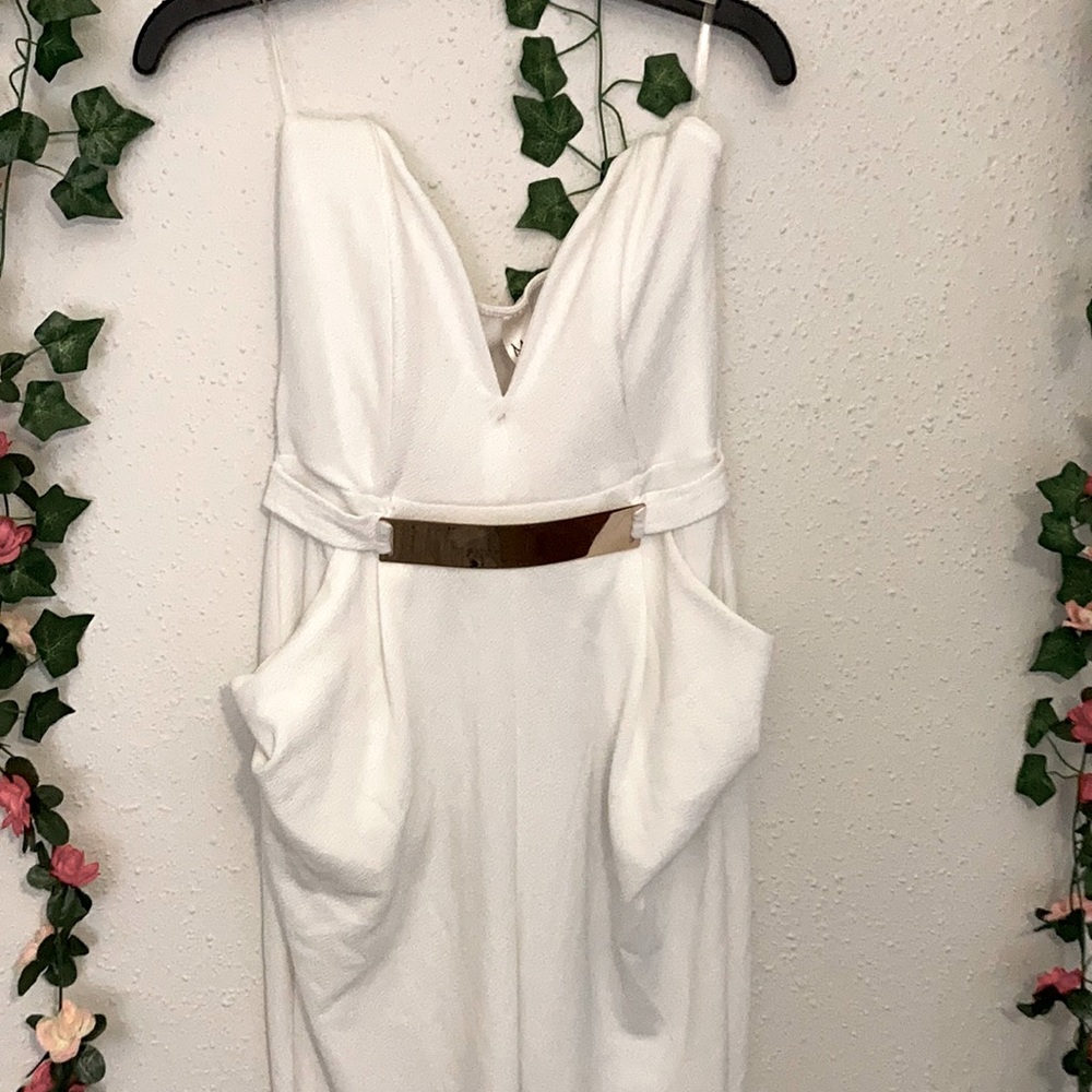 Medium fitted white jumpsuit with gold belt in front with openback made byMonaco